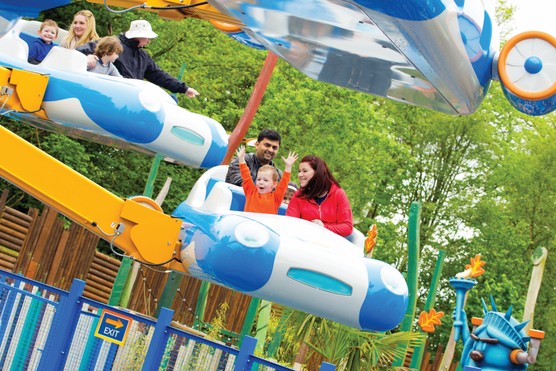 Child and parents on flying ride