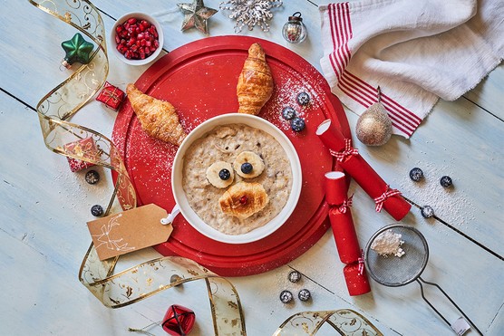 Annabel Karmel's reindeer porridge in bowl surrounded by Christmas decorations