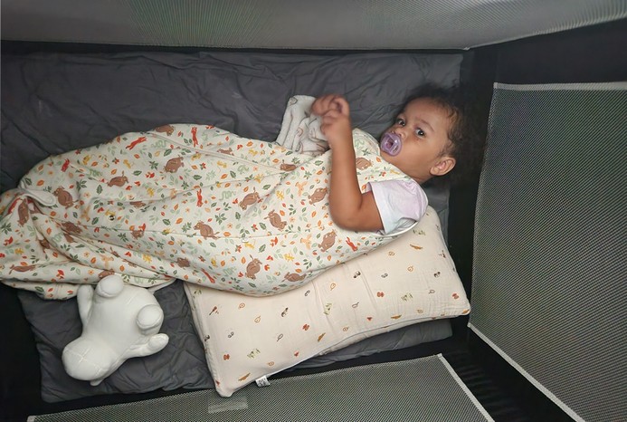 2 pictures of toddler in SlumberPod Blackout Sleep Tent