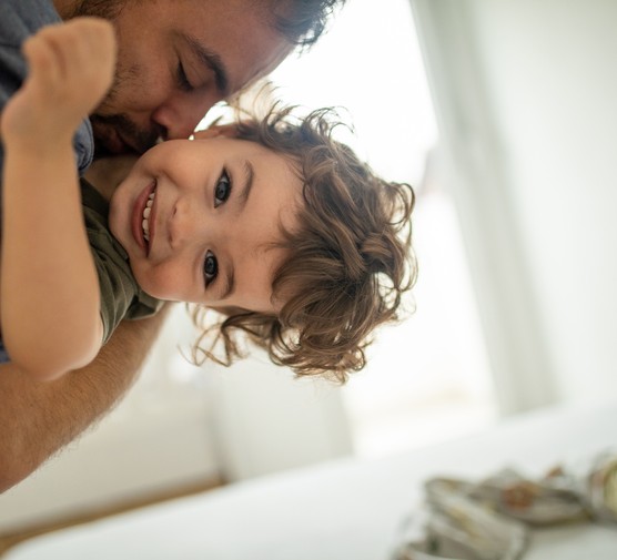 father hugging happy child