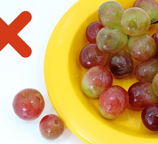 plate of whole grapes and a red cross icon