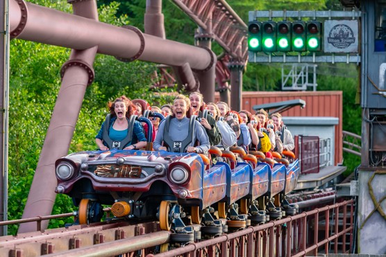 People yelling as a roller coaster takes off