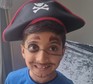 Child with their face painted a pirate and wearing a pirate hat