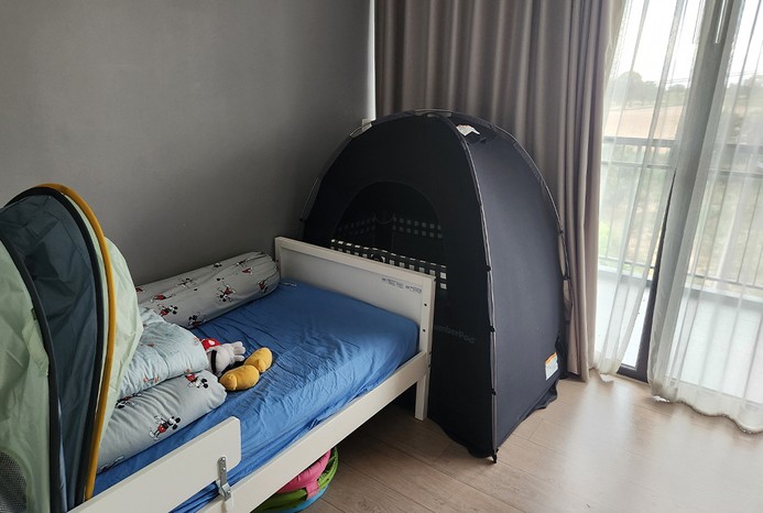 SlumberPod Blackout Sleep Tent set up in the corner of the room SlumberPod Blackout Sleep Tent set up in the corner of the room