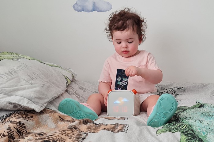 A toddler playing with a Yoto Player