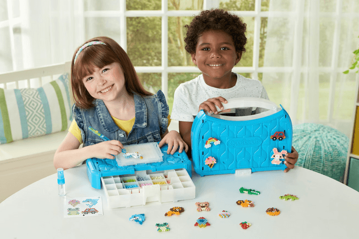 children playing with Aquabeads kit