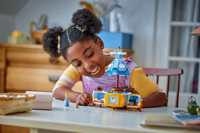 Cinderella's Dress Little girl playing with LEGO Cinderella's Dress model