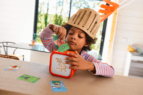 A child putting a Yoto card into a Yoto Player